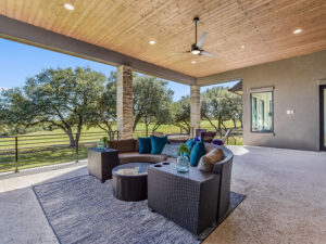 Covered patio attached to a luxury ranch-style home in Lake Travis, TX